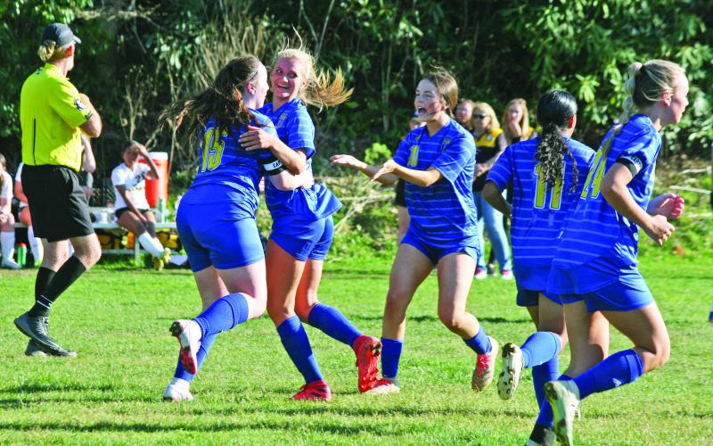 Highlands’ Caroline Woods (15) and Addie Westendorf celebrate after they connected on a corner kick for Highlands third goal of the first half against Murphy on Tuesday night. Highlands went on to win the game 6-2.